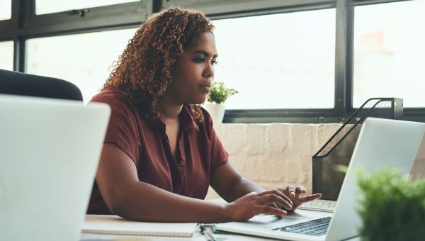 Woman taking notes on her laptop