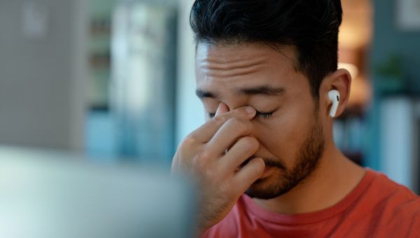 man at computer having eye strain