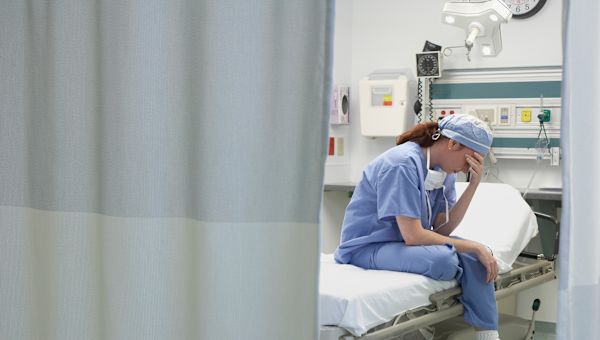 burned out nurse on emergency room bed