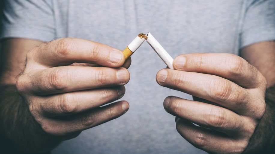 hand breaking a cigarette in half