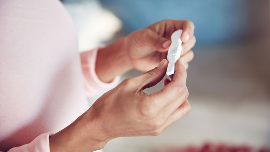 woman holding pregnancy test, pregnancy test