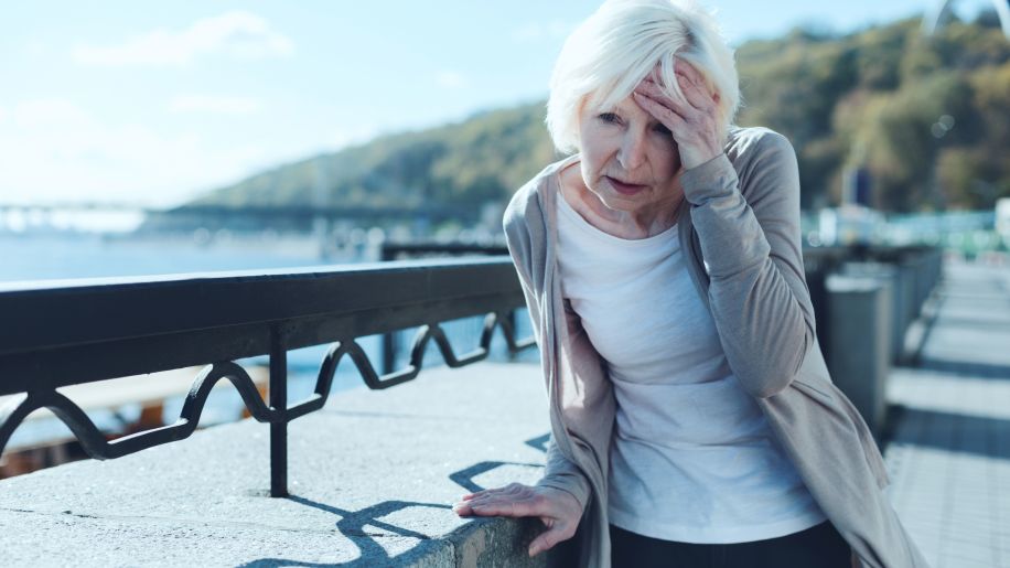 Senior woman experiencing sudden headache