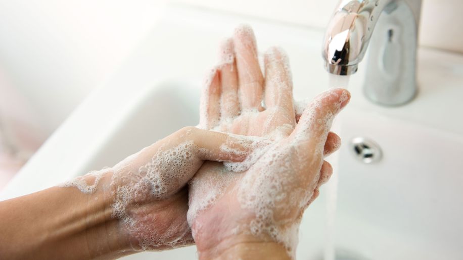 person washing hands, person lathering hands with soap