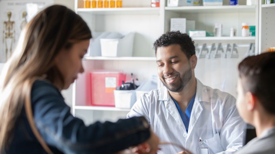 pharmacist giving medications to patient
