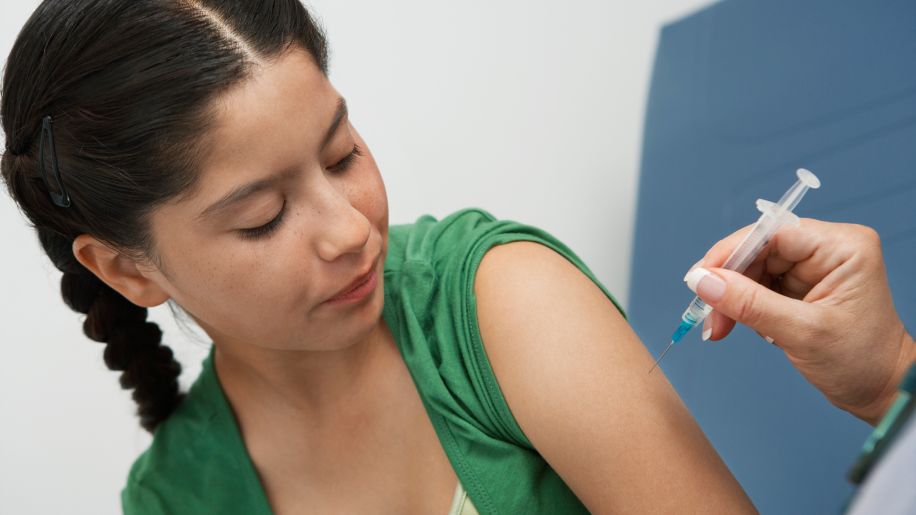 Pre-teen at the doctor getting vaccinated