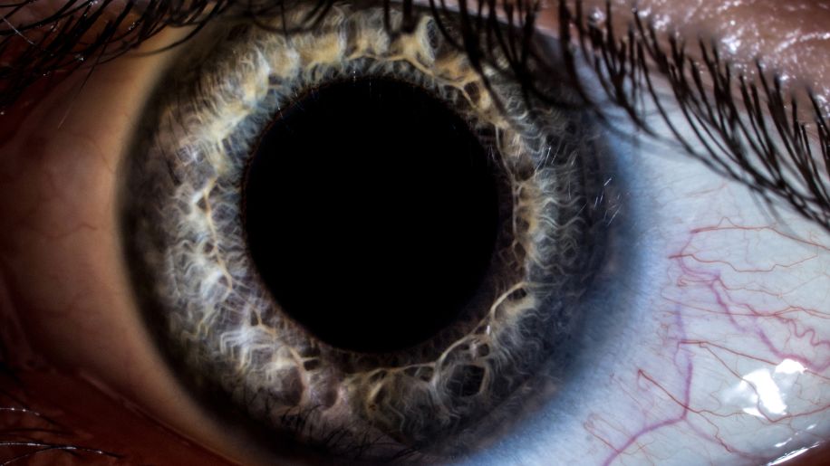 Close up view of an eye with a dilated pupil.
