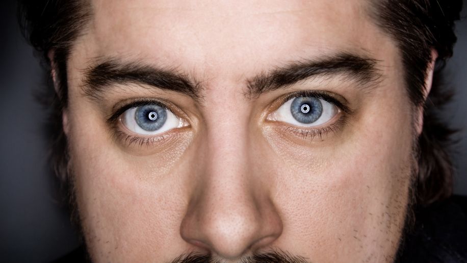 Close up of a man's blue eyes.