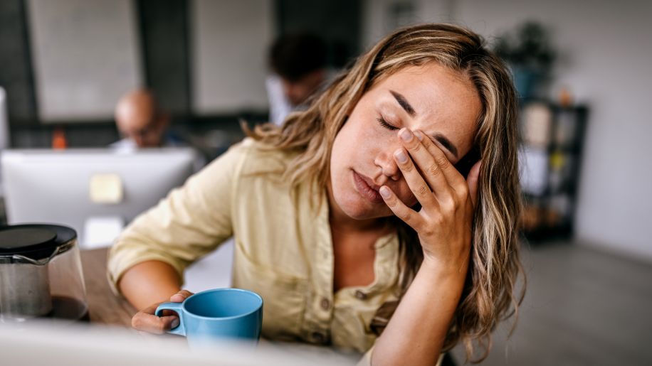 woman having a headache holding her head