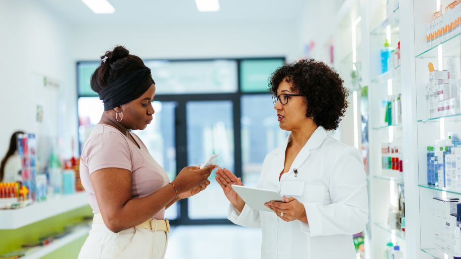 pharmacist giving someone medicine