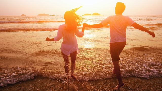 Couple running on beach