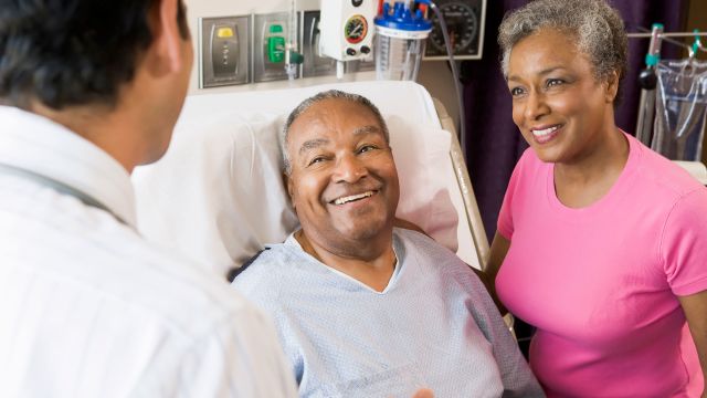 senior couple talking with doctor