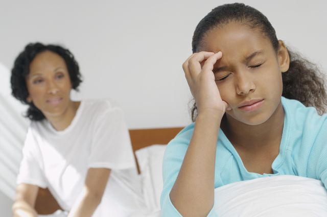 A young girl is having a painful kids' migraine. Her mom wants to try CBT for chronic migraine—chronic behavioral therapy.