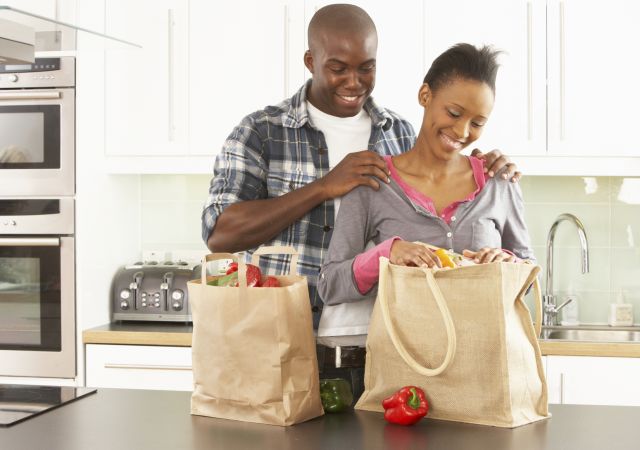 Couple unpacking  grocery bags, reusable grocery bags