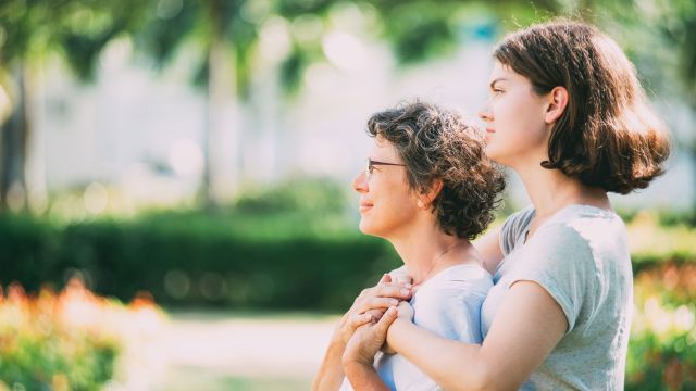 patient and caretaker, woman with multiple sclerosis being comforted by family member