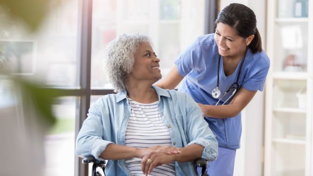 An elderly woman with a UTI is attended to by a nurse. UTI symptoms in older women are often mistaken for natural aging.
