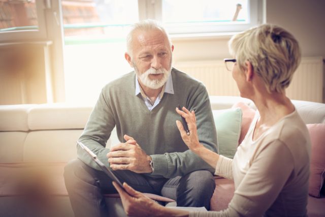 older man discussing documents with a woman