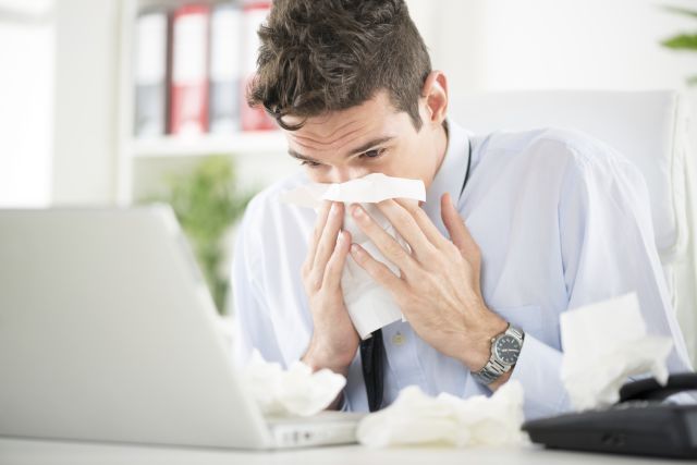 man blowing nose