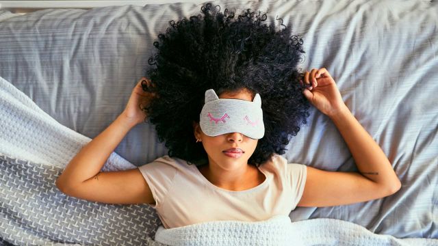 woman laying in bed with arm resting on head