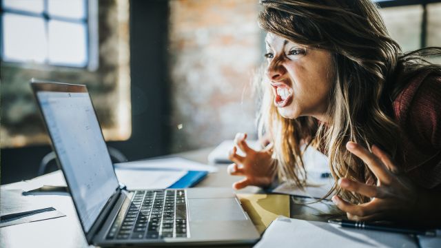 woman screaming at computer