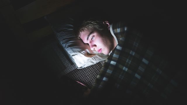 teenager on phone at night