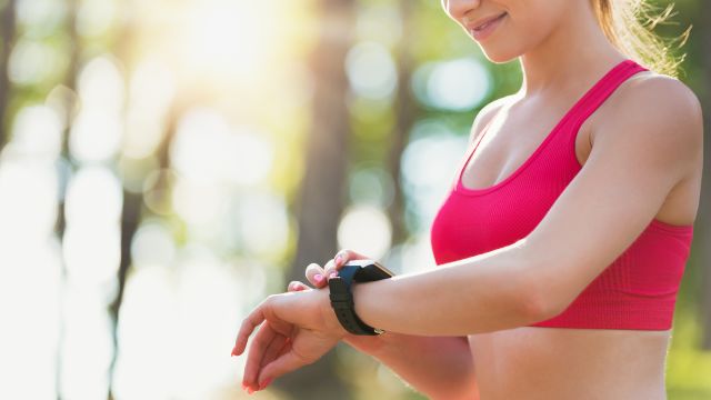 woman on a run using fitness device