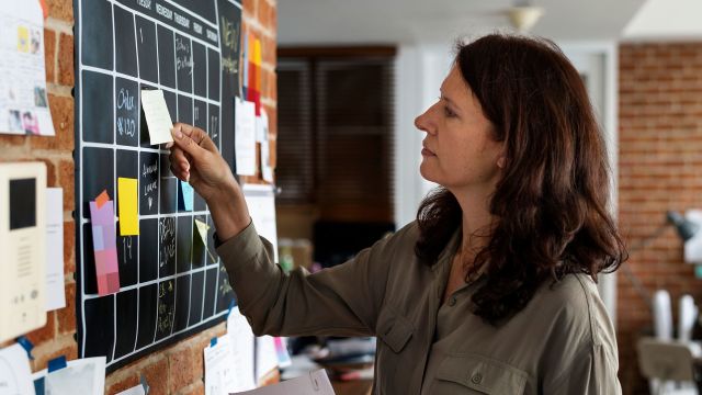 Woman looking at schedule, worried