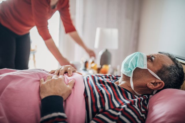 man sick in med wearing face mask