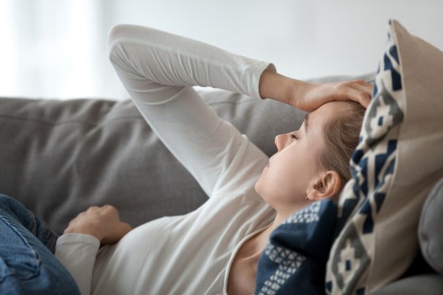 woman with fatigue on sofa