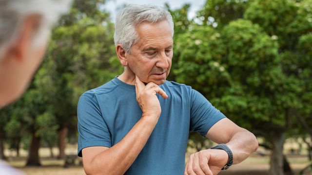 Older man checks heart rate 