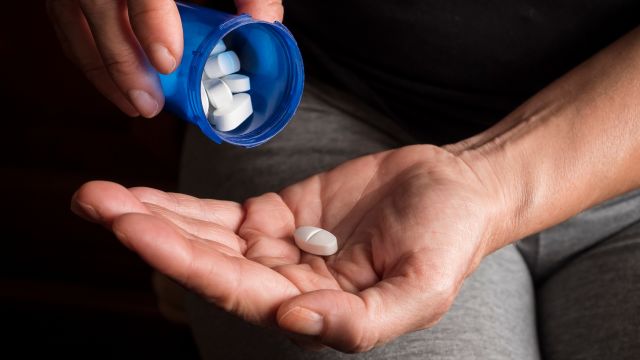 A pill used for feminizing hormone therapy sitting in an open hand.