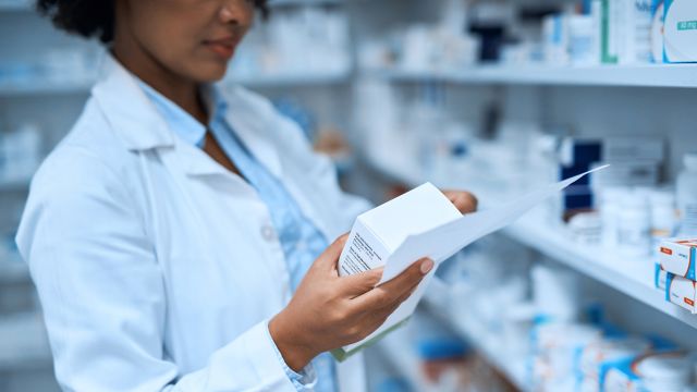 A pharmacist fills a prescription. 