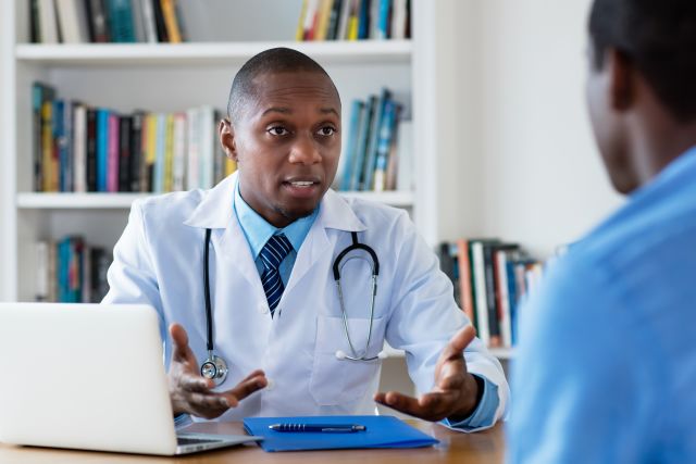 a young doctor speaks with a male patient
