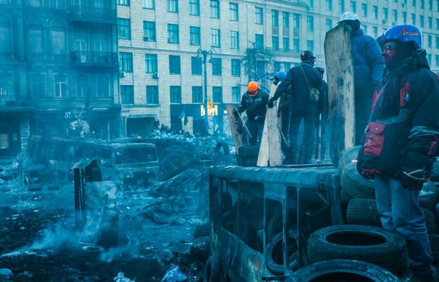 Ukrainians standing amid destruction in Kyiv during Russian invasion