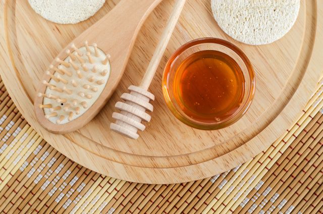 a pot of honey is depicted along with several beauty products 