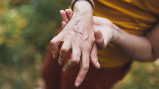 A woman experiences rheumatoid arthritis pain in her wrist.