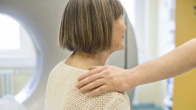 Someone placing their hand on another's person's shoulder for comfort.