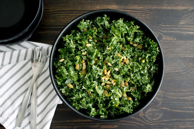 kale salad on a dark brown wood table