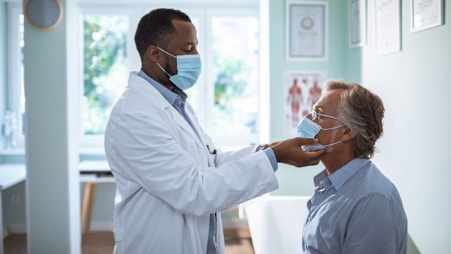 doctor examines lymph nodes.