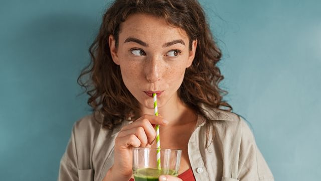 Woman drinking green smoothie