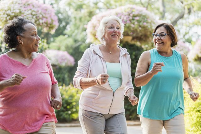 Three older women walking outside