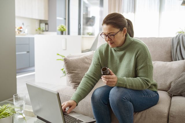 woman researching vitamin on computer