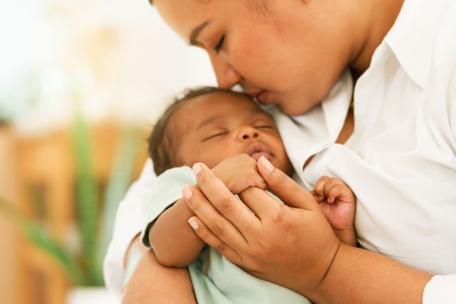 infant being held by woman