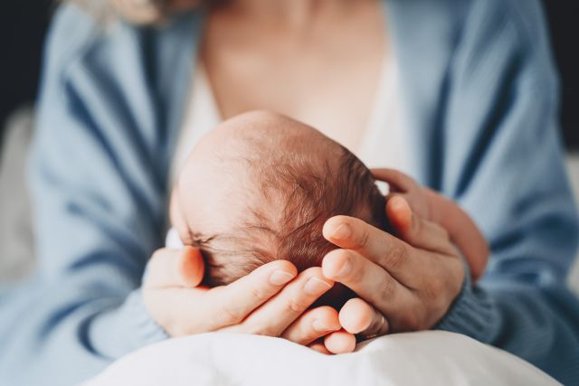 woman holding newborn in hands