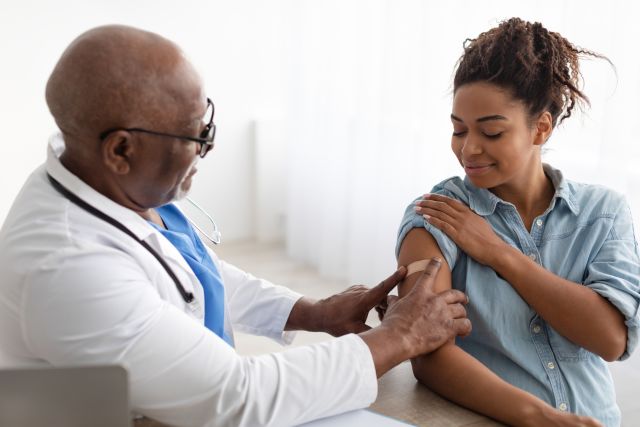 woman receiving vaccination from doctor