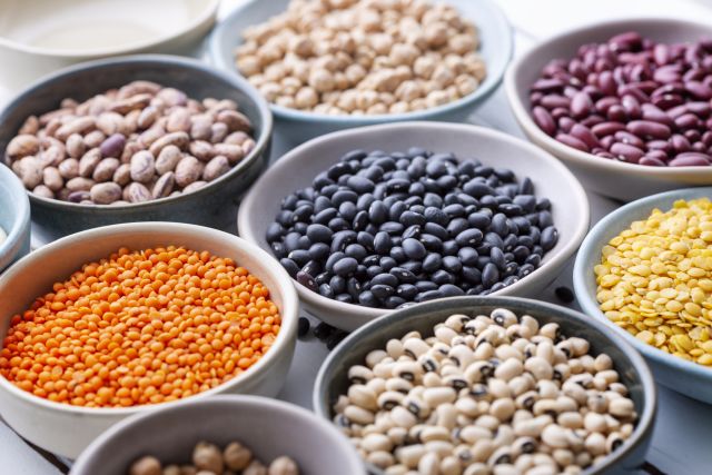 bowls of colorful dried beans and legumes