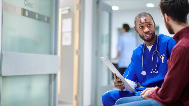 A nurse talking to a patient about hemophilia therapy.