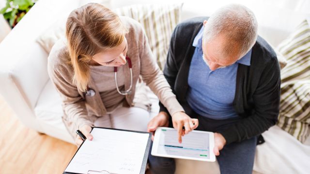 A patient working with a doctor to fill out paperwork for non-hodgkin's lymphoma treatment.