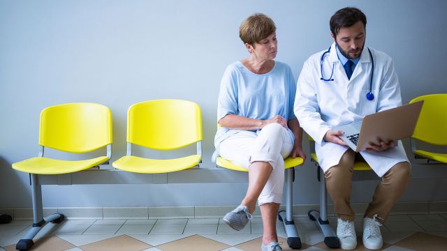 A woman discussing her lymphoma diagnosis with a doctor.