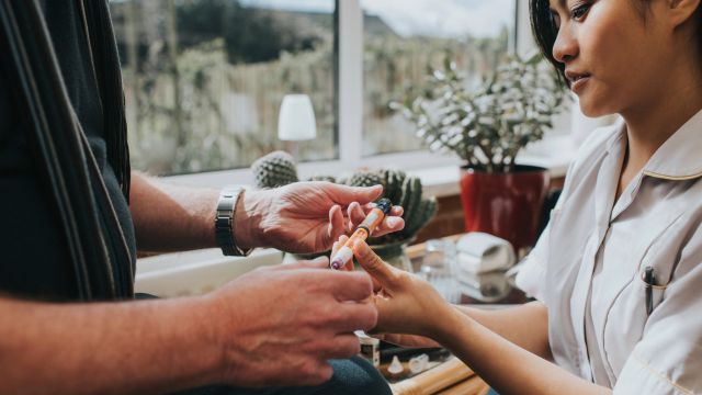 A diabetes educator instructs a patient how to inject insulin with an insulin pen.