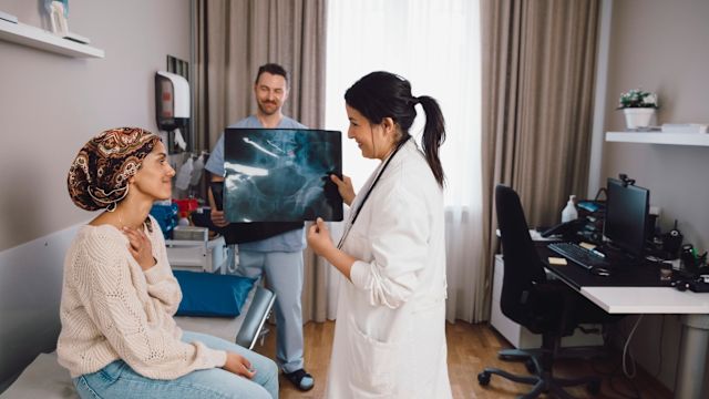 A woman speaks with her oncologist about the results of a scan to check for breast cancer recurrence. Regular appointments and exams are an important part of follow-up care after breast cancer treatment.